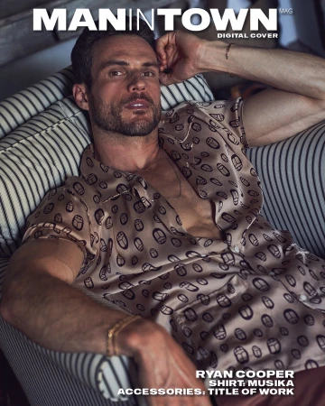 Ryan Cooper sits in a striped chair wearing a patterned shirt in a magazine cover shot with muted colors and studio lighting.