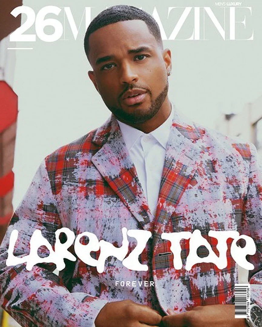 Magazine cover featuring a stylish mixed-race adult male in a patterned suit, captured in a medium shot against a blurred outdoor backdrop.