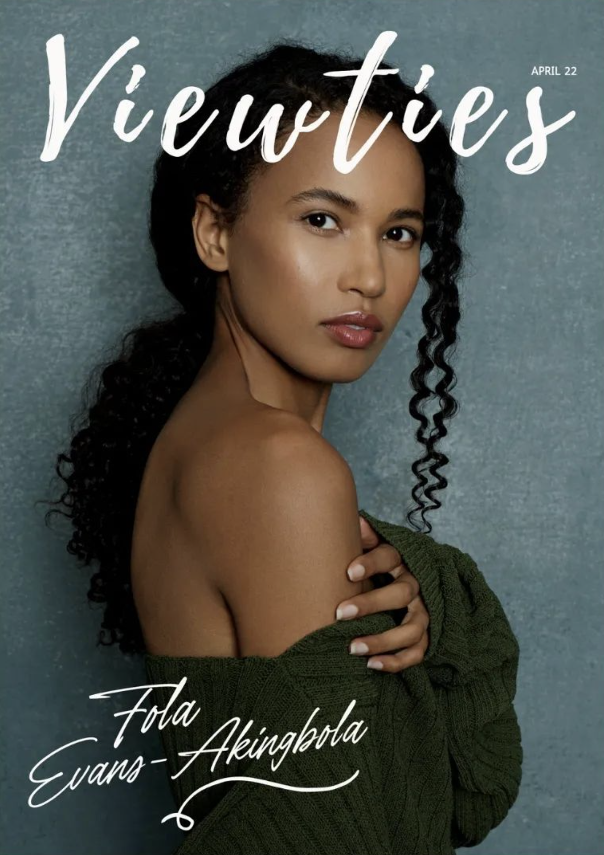 Portrait of Fola Evans Akingbola wearing a green knitted sweater against a textured blue background with magazine typography