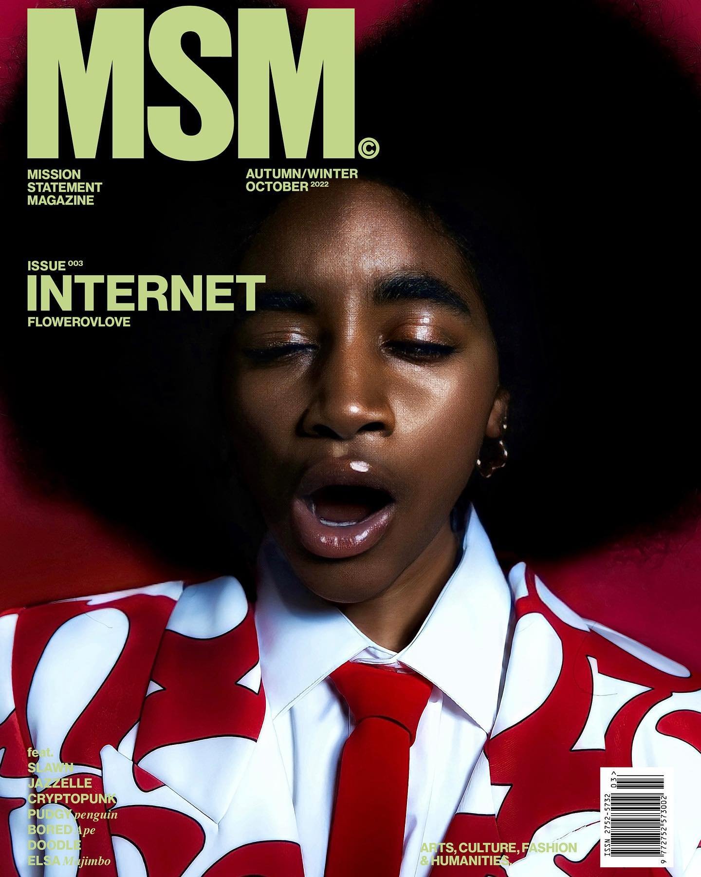 Magazine cover featuring a young adult with an open mouth, wearing a patterned blazer and tie, against a dark red backdrop.