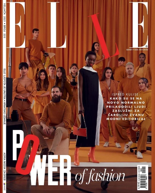 Elle magazine cover featuring a group of fashion models in coordinated orange and brown outfits, set against a warm orange backdrop.