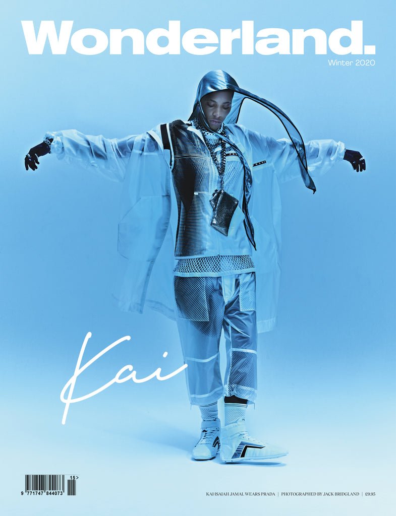 Wonderland magazine cover featuring a person in avant-garde clear vinyl hooded jacket and pants standing in a light blue studio.