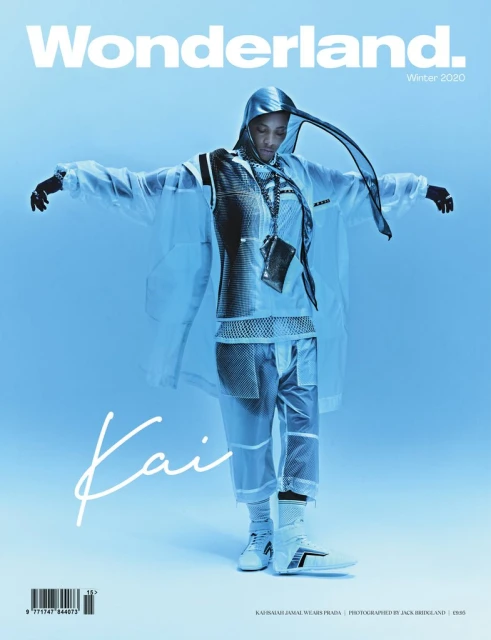 Wonderland magazine cover featuring a person in avant-garde clear vinyl hooded jacket and pants standing in a light blue studio.