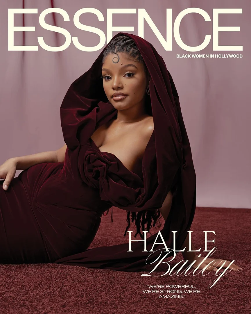 Essence magazine cover featuring Halle Bailey in a burgundy gown lying on a matching carpet with elegant script typography.