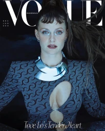 Portrait of singer Tove Lo with dark patterned dress, silver choker, and swept-back hair for magazine cover