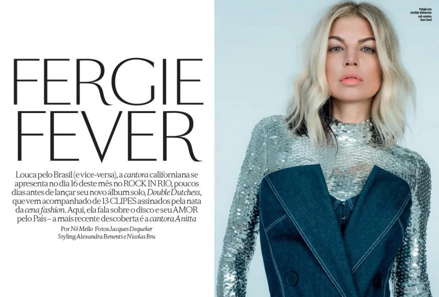 Fashion editorial portrait of Fergie in a sequined top and denim jacket. Indoor shot, the singer looks directly at the camera.