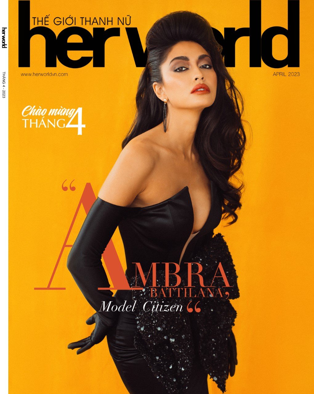 Her World magazine cover featuring a brunette woman in an elegant black dress against a vivid yellow backdrop, April 2023 edition.