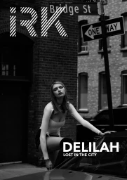 Monochrome fashion editorial featuring a model posing near a street sign and a car styled by Olivia Rose