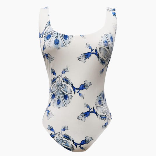 White one-piece swimsuit with a blue floral pattern, displayed on a white background, suitable for fashion and swimwear themes.