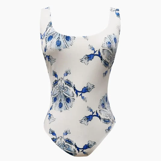 White one-piece swimsuit with a blue floral pattern, displayed on a white background, suitable for fashion and swimwear themes.