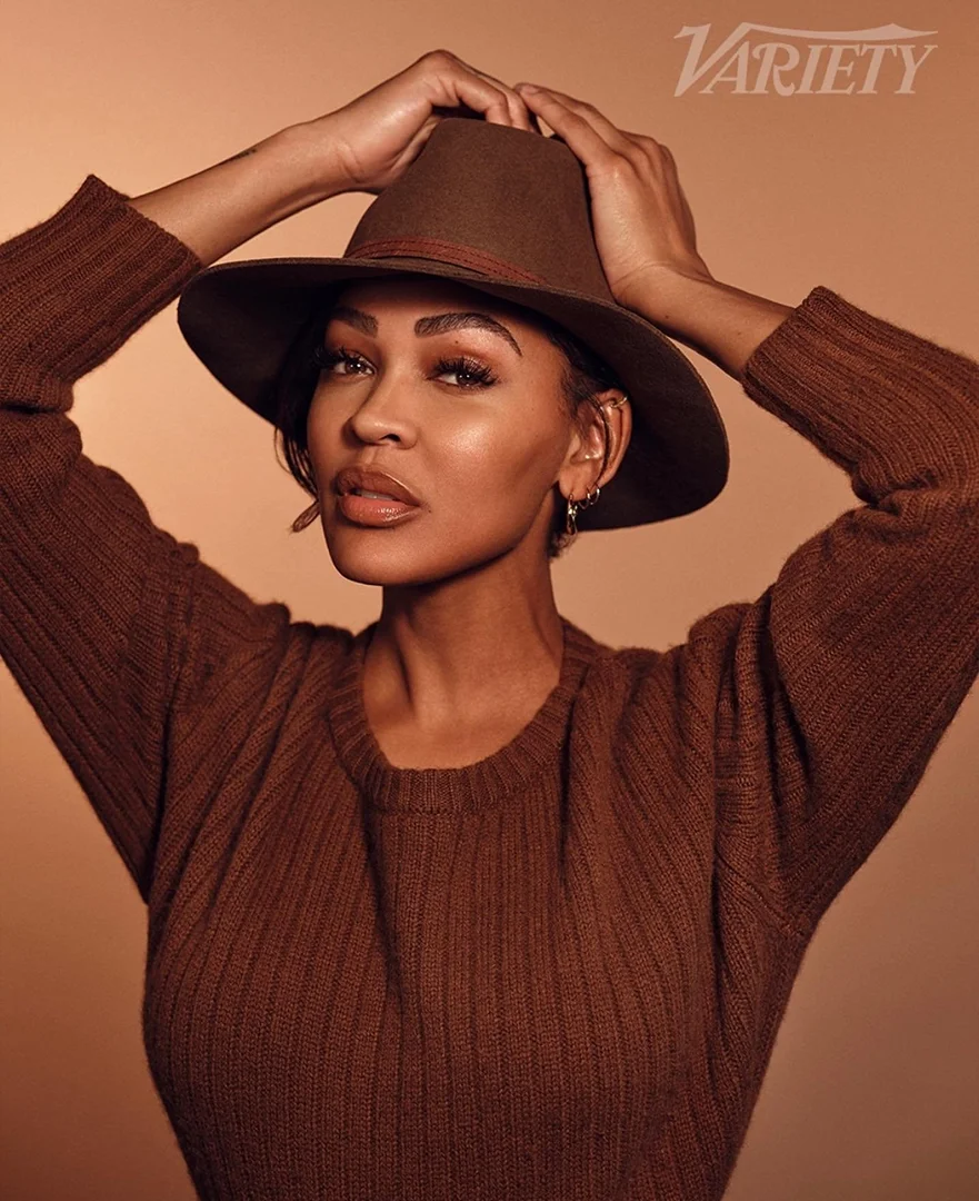 Meagan Good wearing a brown sweater and fedora hat, styled by Philippe Uter in Los Angeles.