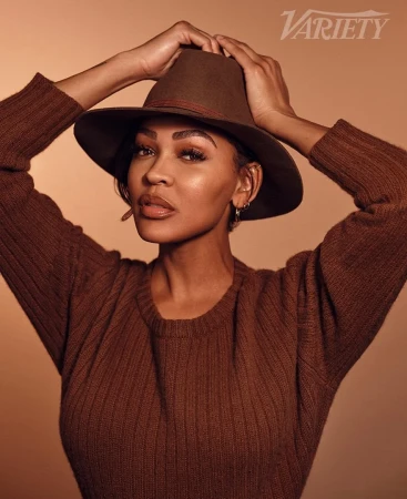Meagan Good wearing a brown sweater and fedora hat, styled by Philippe Uter in Los Angeles.