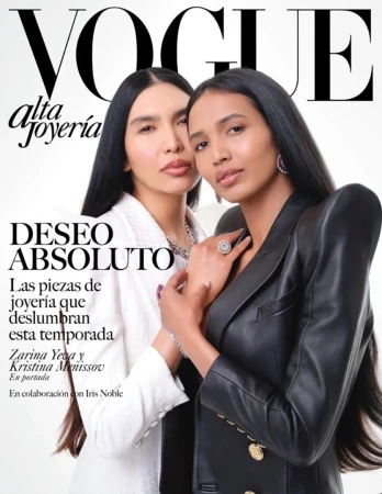 Vogue magazine cover featuring two women in blazers and jewelry, with the magazine's masthead and article titles visible.