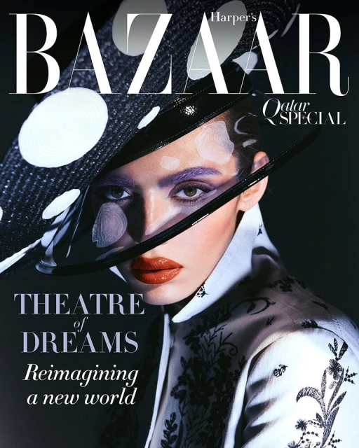Fashion editorial portrait of a woman with dramatic makeup and a wide-brimmed polka dot hat, featured on the cover of Harper's Bazaar.