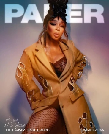 Portrait of Tiffany Pollard wearing an embellished camel coat and fishnet tights with dramatic updo hair