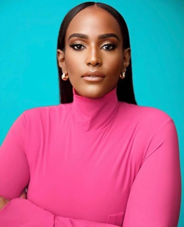 Portrait of a woman with long dark hair wearing a hot pink turtleneck against a bright blue background
