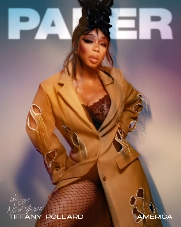 Woman in a beige cut-out blazer and fishnet tights with elaborate dark hair styling and make-up by Renee Sanganoo.