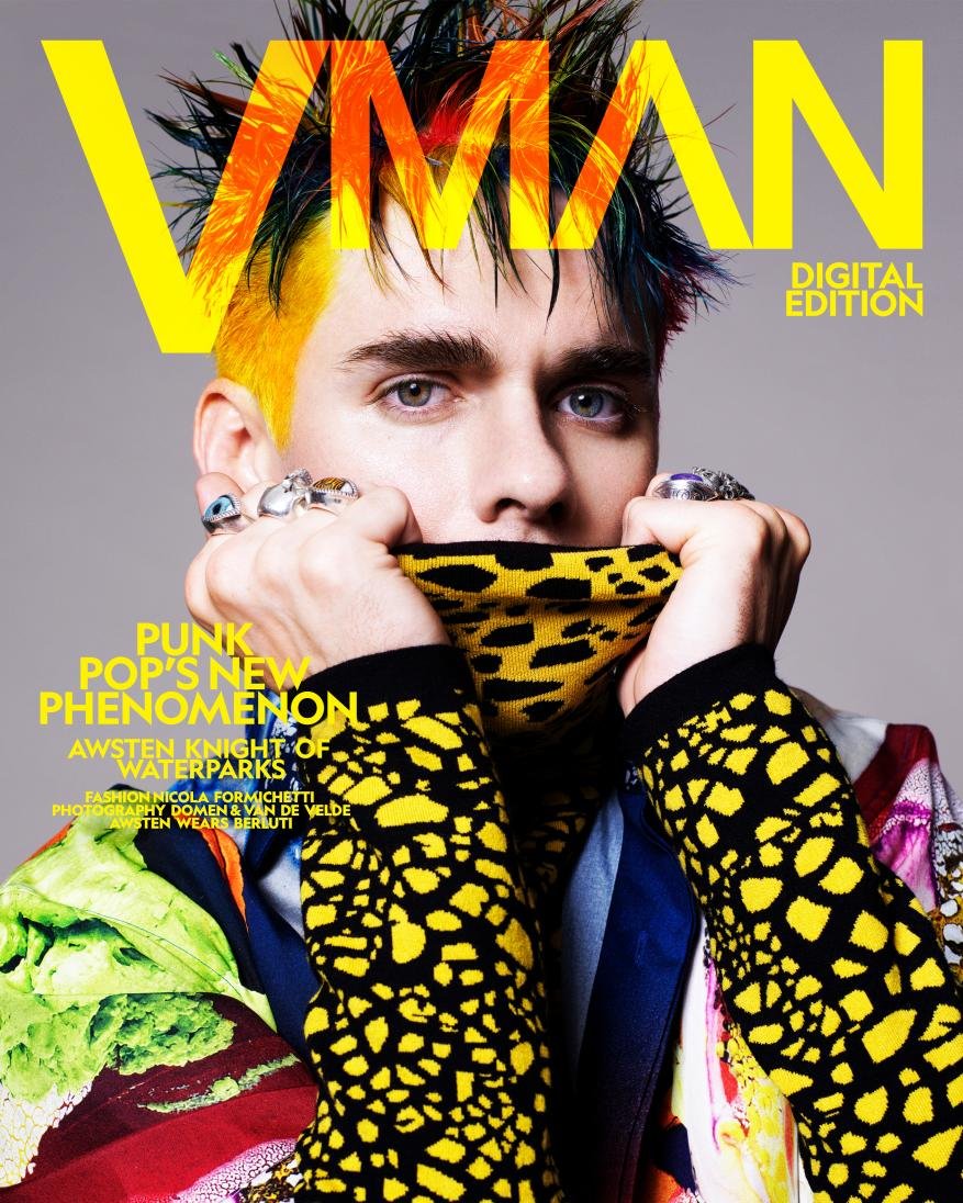 Magazine cover features a young adult male with colorful hair, distinctive rings, and a patterned jacket, gazing intently at the viewer.