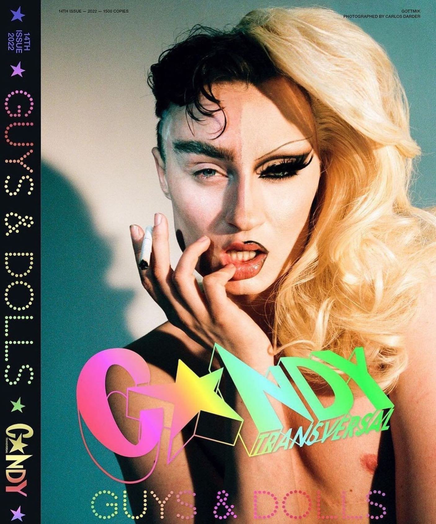 Magazine cover featuring a gender-fluid model with striking makeup, half blonde wig, and cigarette, set against a neutral backdrop.