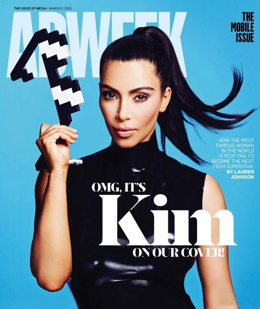 Adweek magazine cover featuring Kim Kardashian wearing a black top and holding a pixelated game controller against a blue background.
