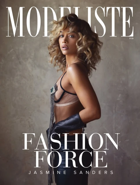 Fashion magazine cover featuring Jasmine Sanders in a black leather glove and decorative top against a muted background.