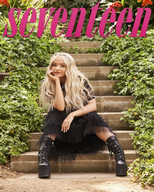 Teen magazine cover featuring Dove Cameron sitting on stone steps surrounded by green foliage wearing a black dress and platform boots.
