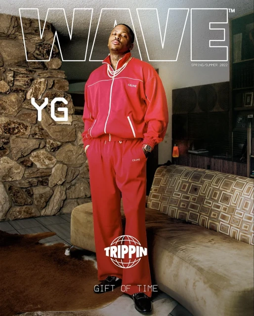 Magazine cover featuring YG in a red tracksuit standing in a room with a stone fireplace, patterned couch, and text overlay.