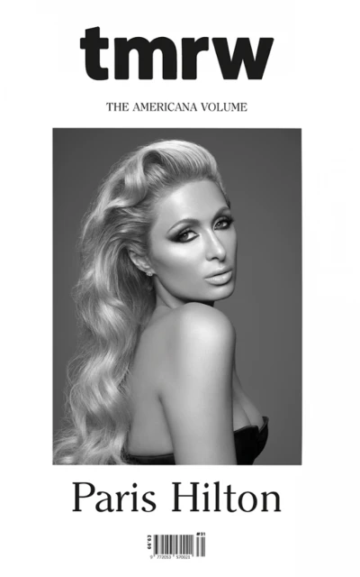 Black-and-white magazine cover featuring Paris Hilton with blonde hair, dark eye makeup, and a strapless dress on a grey backdrop.