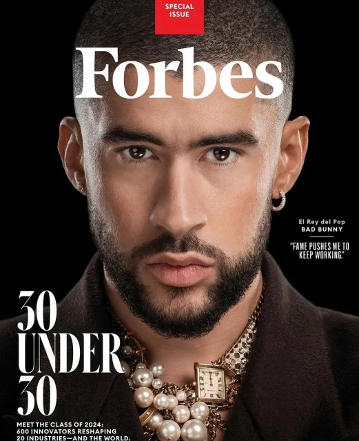 Forbes magazine cover features Bad Bunny in close-up wearing jewelry on a dark background. The '30 Under 30' special issue.