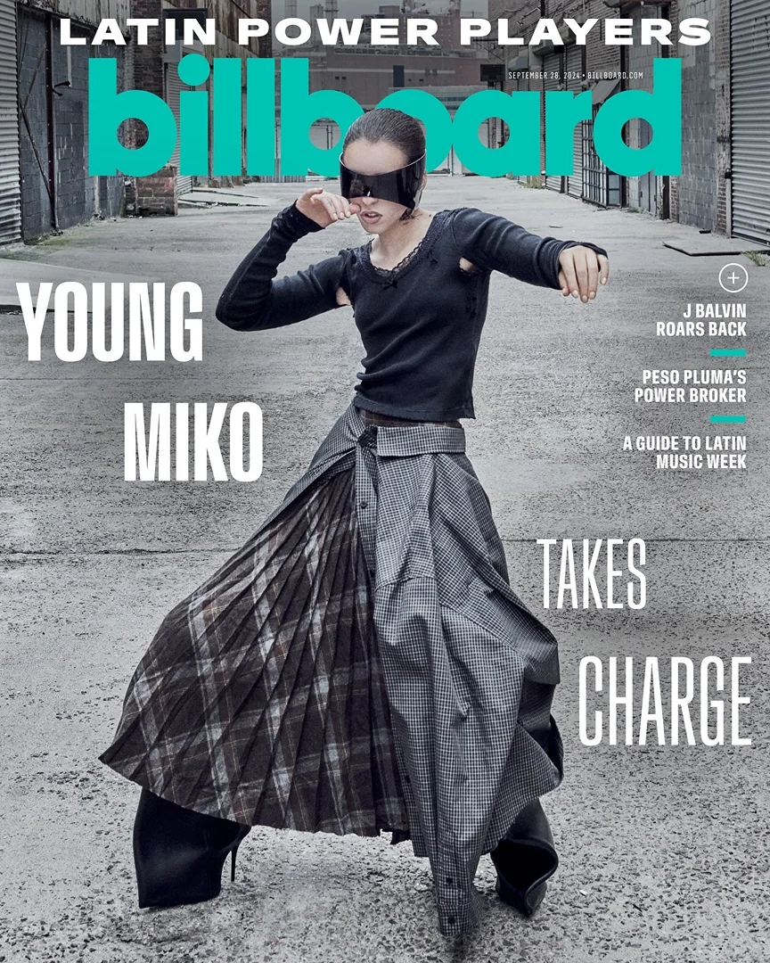 Billboard magazine cover featuring Young Miko in sunglasses and plaid skirt, posing on an outdoor city street with magazine text overlays.
