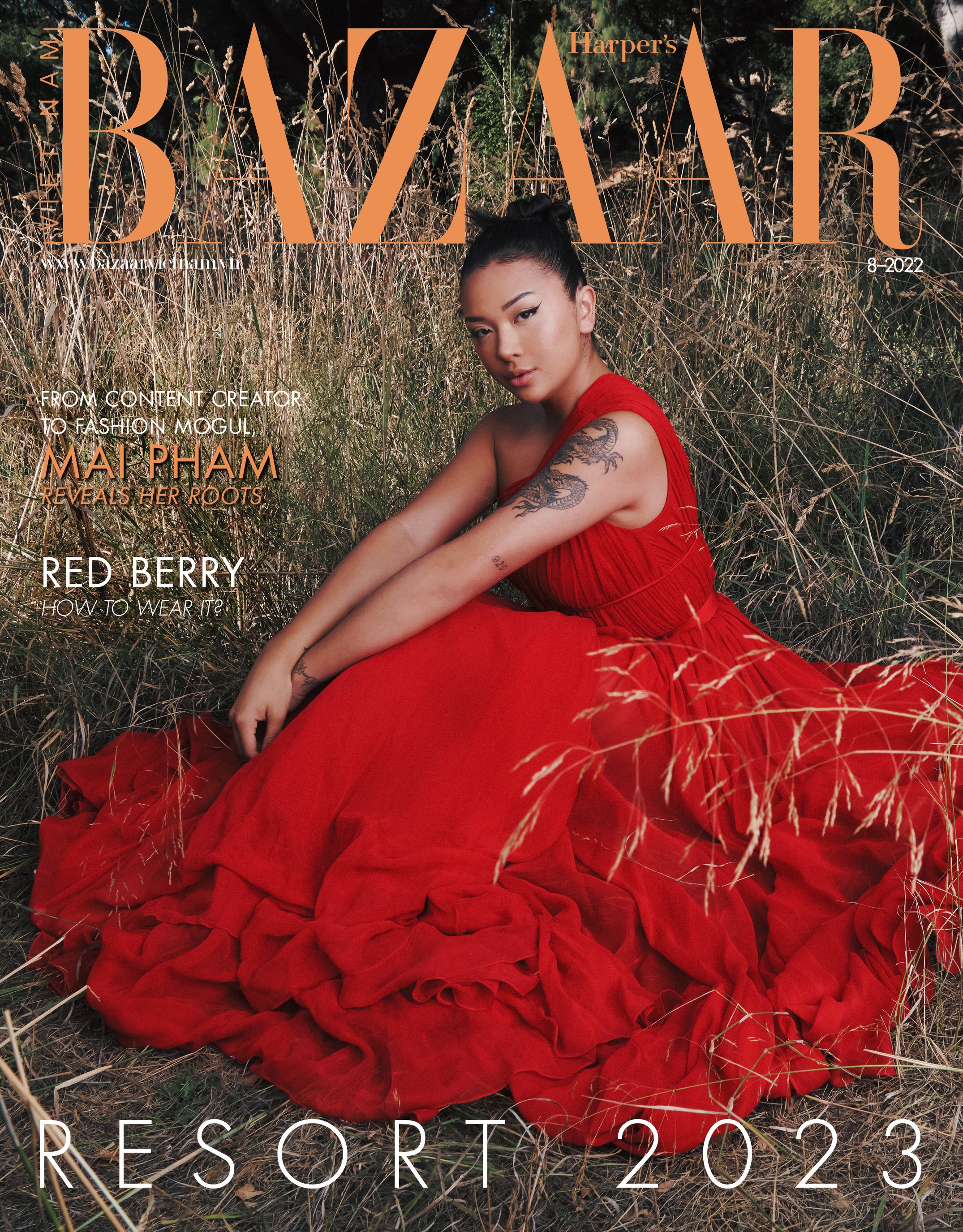Magazine cover featuring Mai Pham in a red gown sitting in a grassy field. Bazaar logo at the top, Resort 2023 text at the bottom.