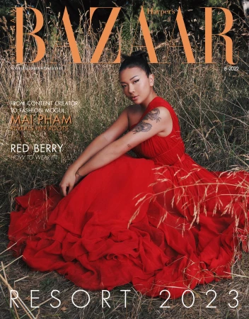 Magazine cover featuring Mai Pham in a red gown sitting in a grassy field. Bazaar logo at the top, Resort 2023 text at the bottom.