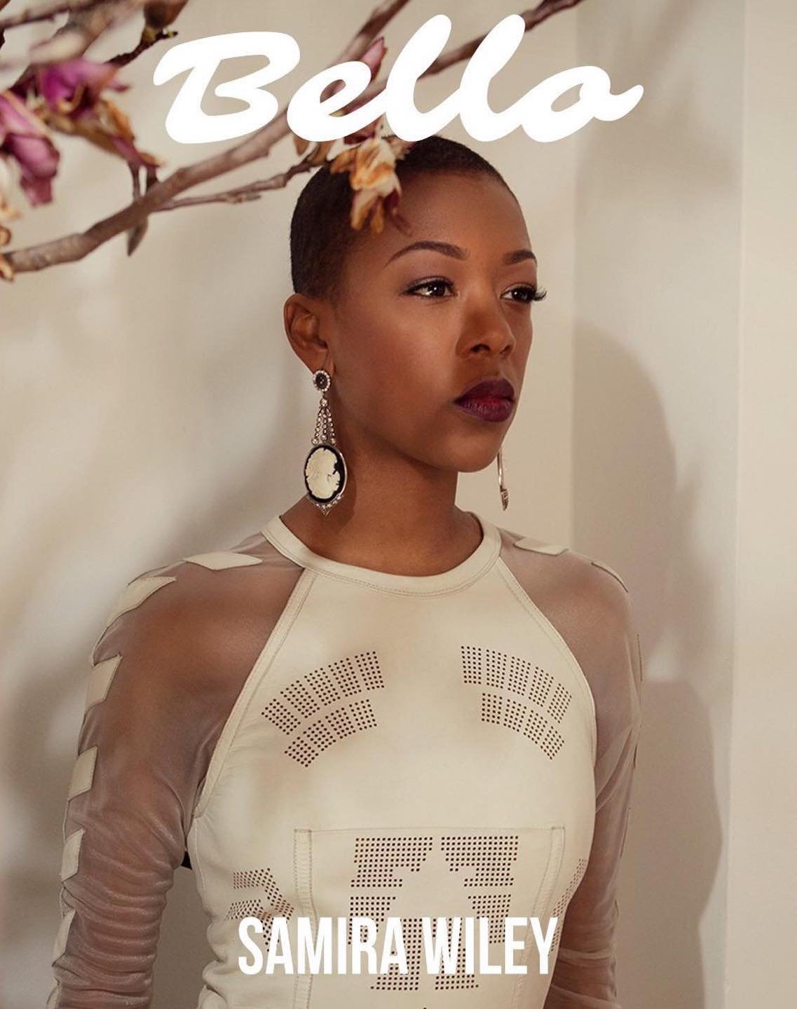 Headshot of African-American adult female with short hair, wearing a cream top with sheer sleeves, against a neutral backdrop.