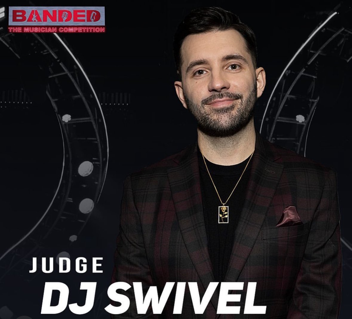 Headshot of DJ Swivel, a musician competition judge, wearing a black shirt, gold necklace, and plaid jacket against a dark backdrop.