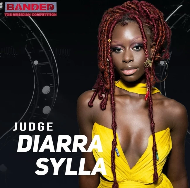 Portrait of Diarra Sylla, 'Banded' musician competition judge, wearing a yellow dress and red dreadlocks against a dark backdrop.