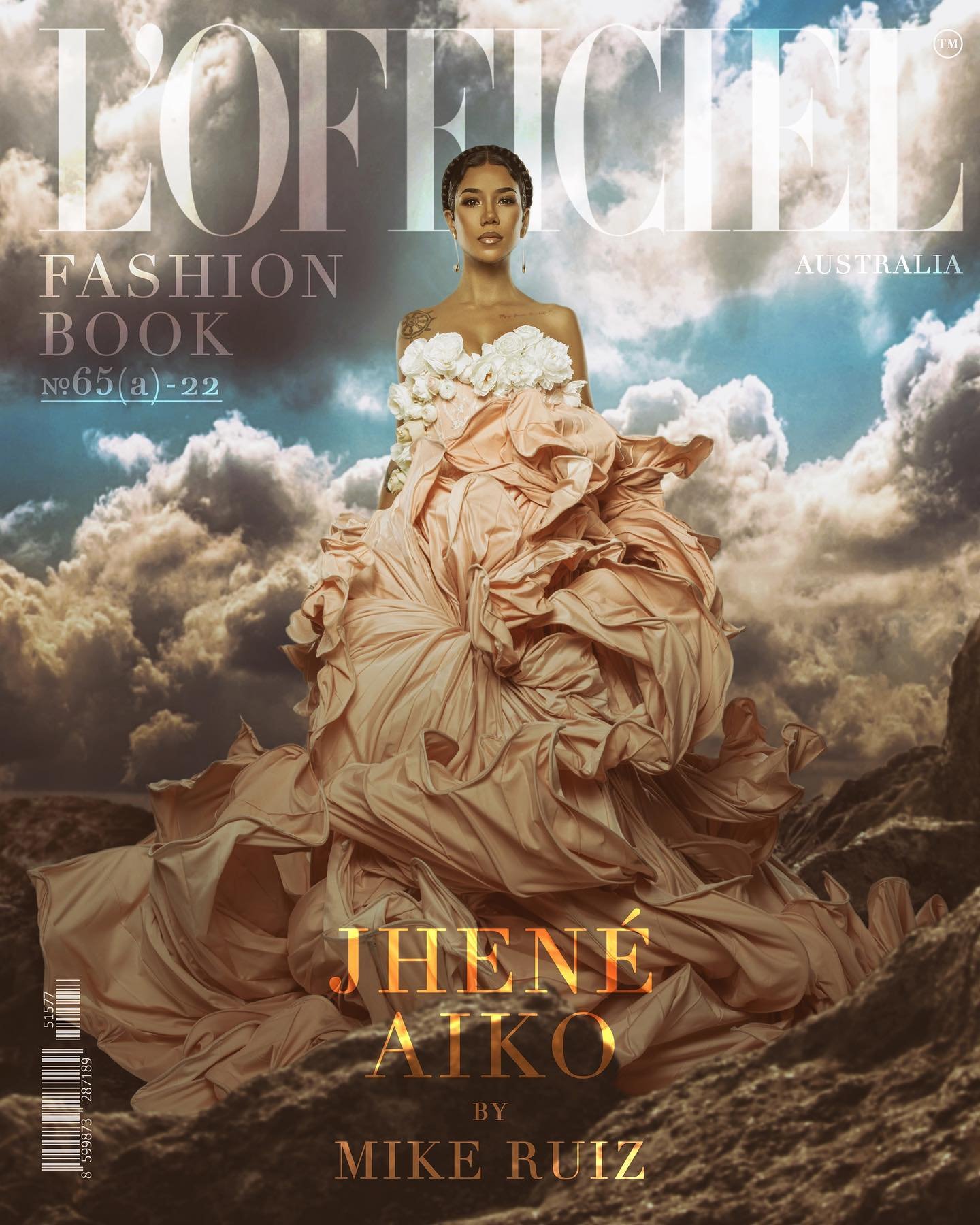 Fashion magazine cover featuring a woman in a large flowing dress against a sky and landscape background, promoting L'Officiel Australia.