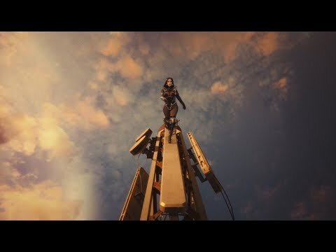 Woman in a futuristic suit standing atop a tall metal structure against a cloudy sky, creating a striking and dynamic visual.