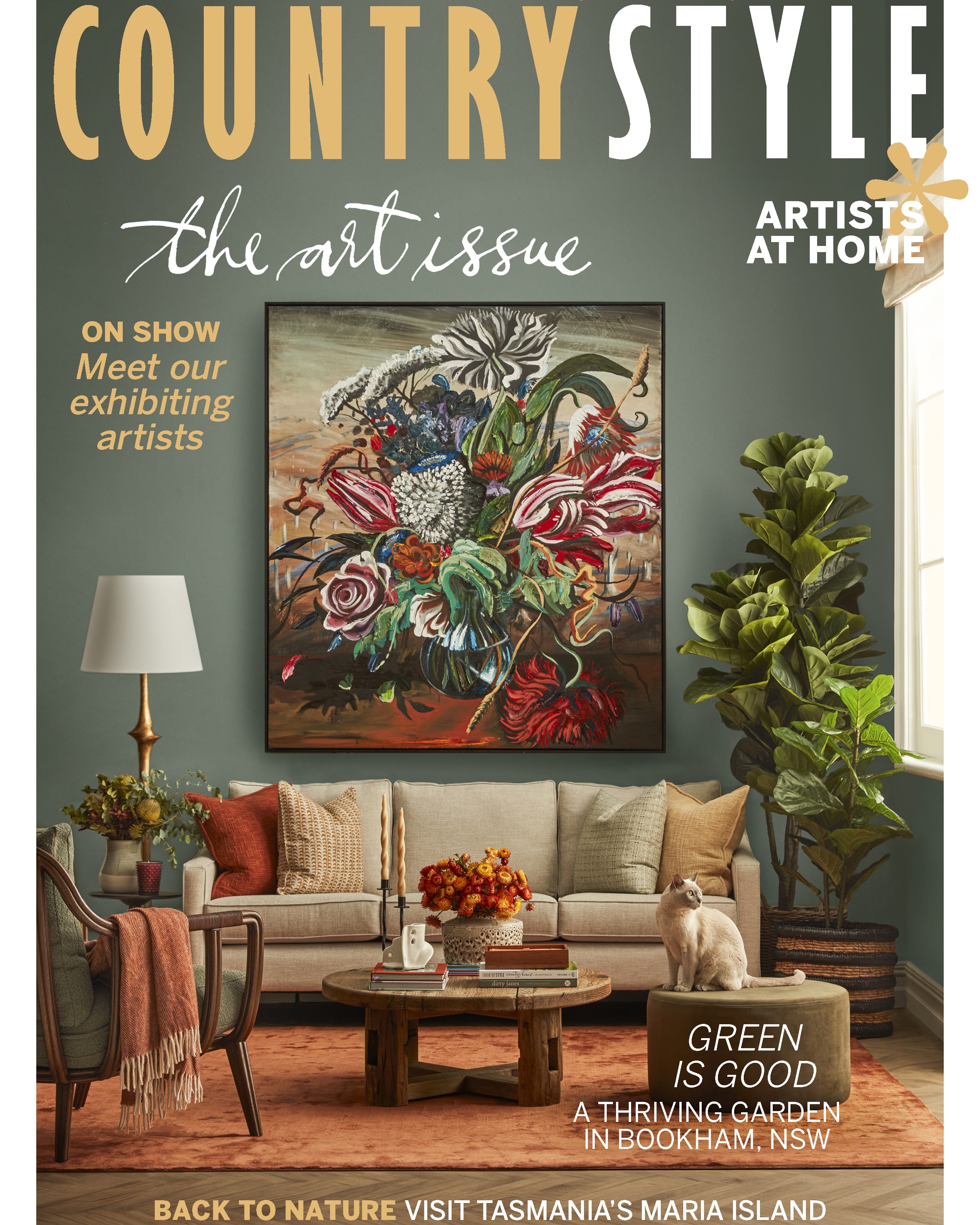 Living room interior featuring a beige sofa with throw pillows, a floral painting, a coffee table, and a cat, showcasing home decor and artistry.