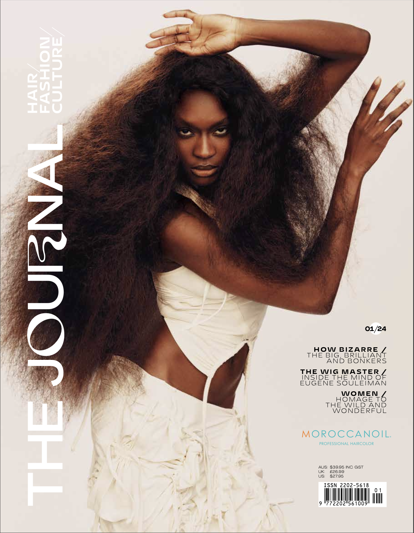 Fashion magazine cover featuring a Black female model with voluminous dark hair, wearing a white outfit against a neutral background.
