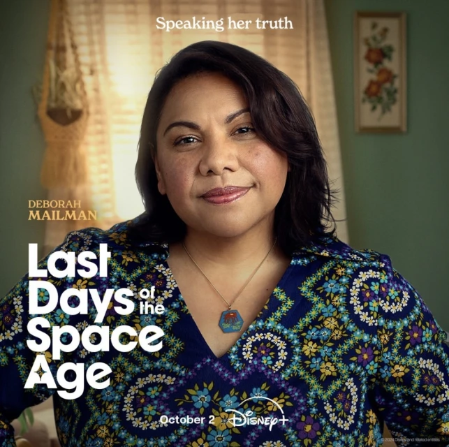 Headshot of Deborah Mailman against a muted green wall with floral art, promoting the 'Last Days of the Space Age' series on Disney+.