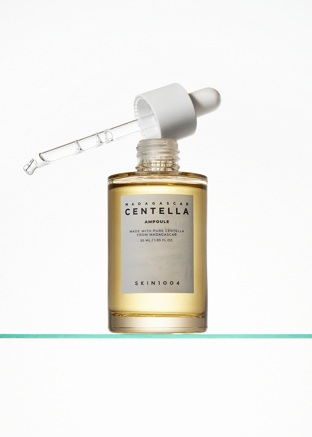 A skincare product bottle with a dropper, featuring the brand name Madagascar Centella Ampoule, displayed against a bright white background.