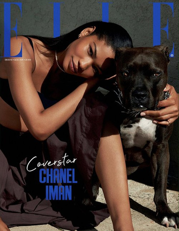 Chanel Iman magazine cover with a pitbull dog. The model is resting her head on the dog. The masthead reads ELLE in a large font.