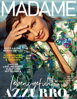Model Angela Lindvall in a floral printed top posing outdoors near water for Madame magazine photographed by Sylve Colless.