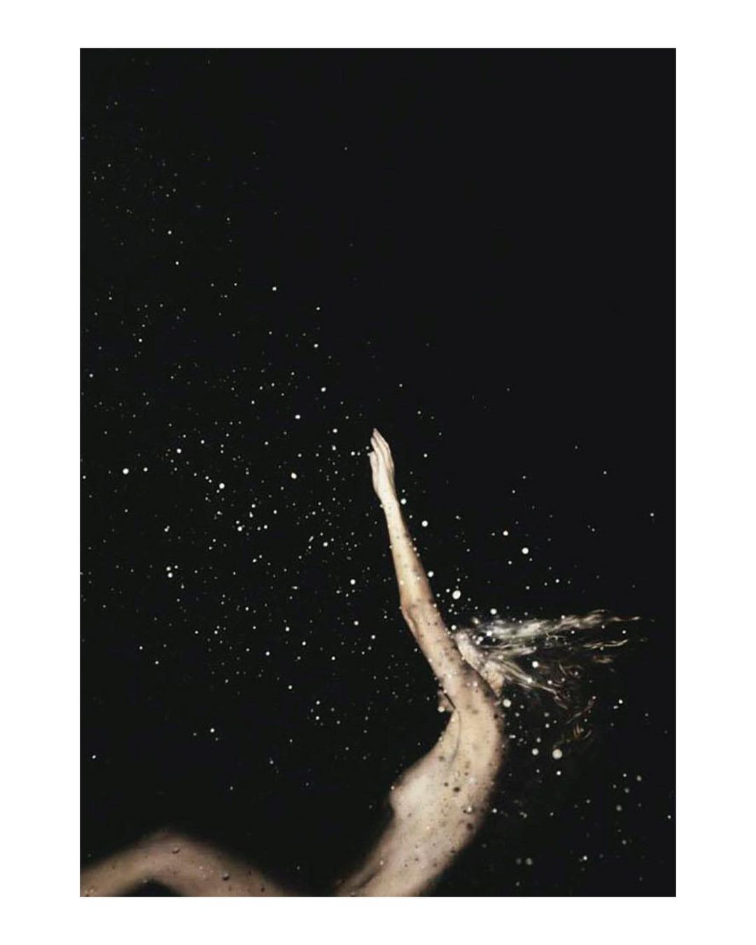 Abstract art of female figure reaching upward against a dark, speckled background, creating a sense of ethereal movement and cosmic connection.