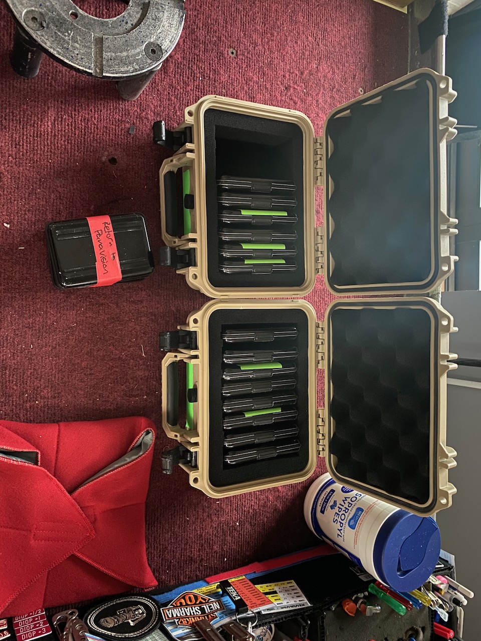 Organized storage solution featuring two open, tan-colored hard cases filled with flash media cards, resting on a patterned surface.