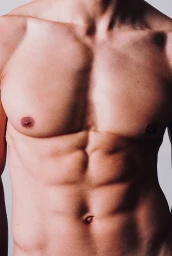 Close up portrait of a man showing his muscular torso and abs against a light background