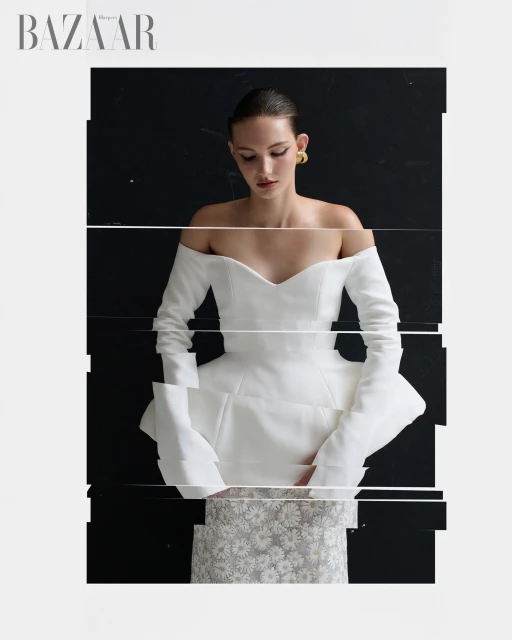 Fashion editorial shot of a woman in a white off-the-shoulder dress with a digitally glitched effect, set against a dark background.