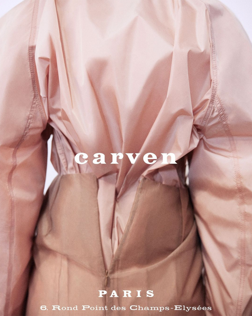 Close-up rear view of a light pink Carven garment, showcasing its design, textures, and construction details, against a neutral backdrop.