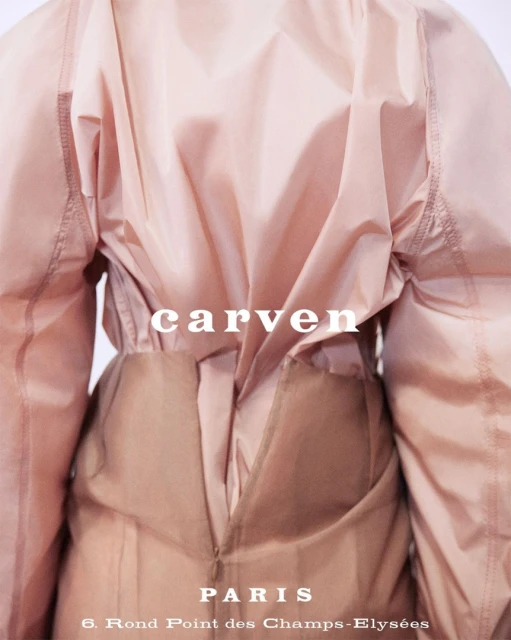 Close-up rear view of a light pink Carven garment, showcasing its design, textures, and construction details, against a neutral backdrop.