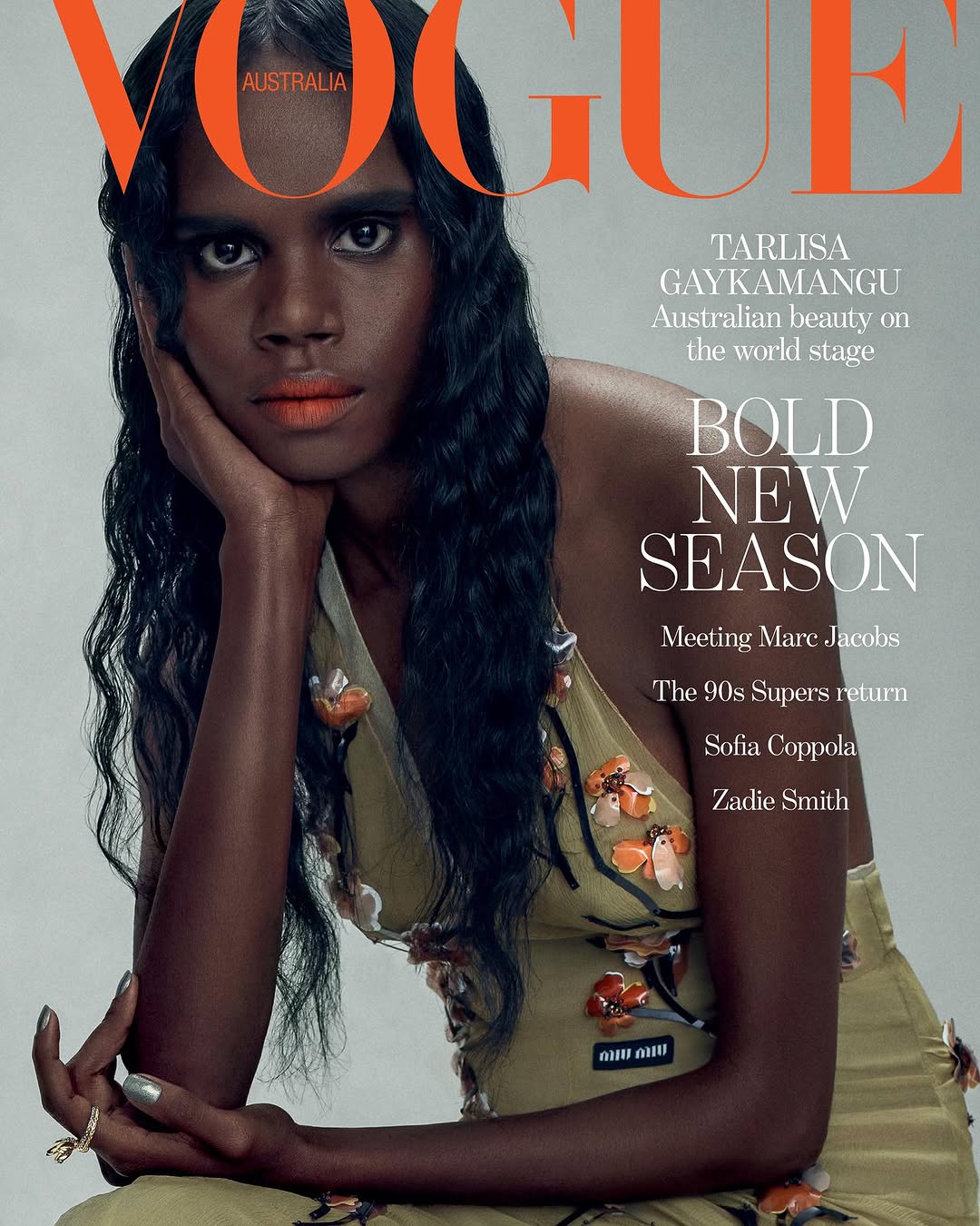 Vogue Australia magazine cover featuring model Tarlisa Gaykamangu with floral dress, dark hair, orange lipstick, and silver fingernails.